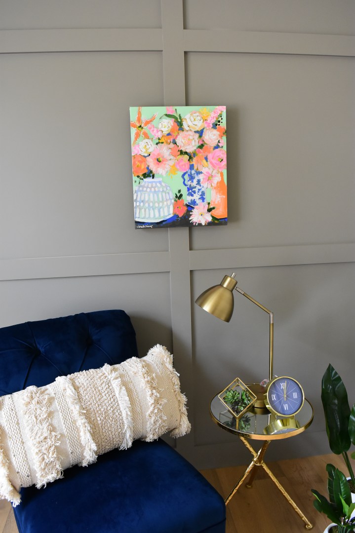 floral painting in orange and white jars with mint blue background.