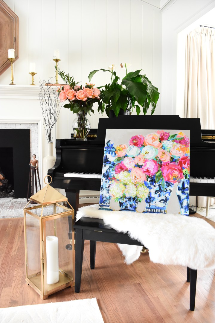 floral painting with blue and white ginger jars on piano with gold lantern